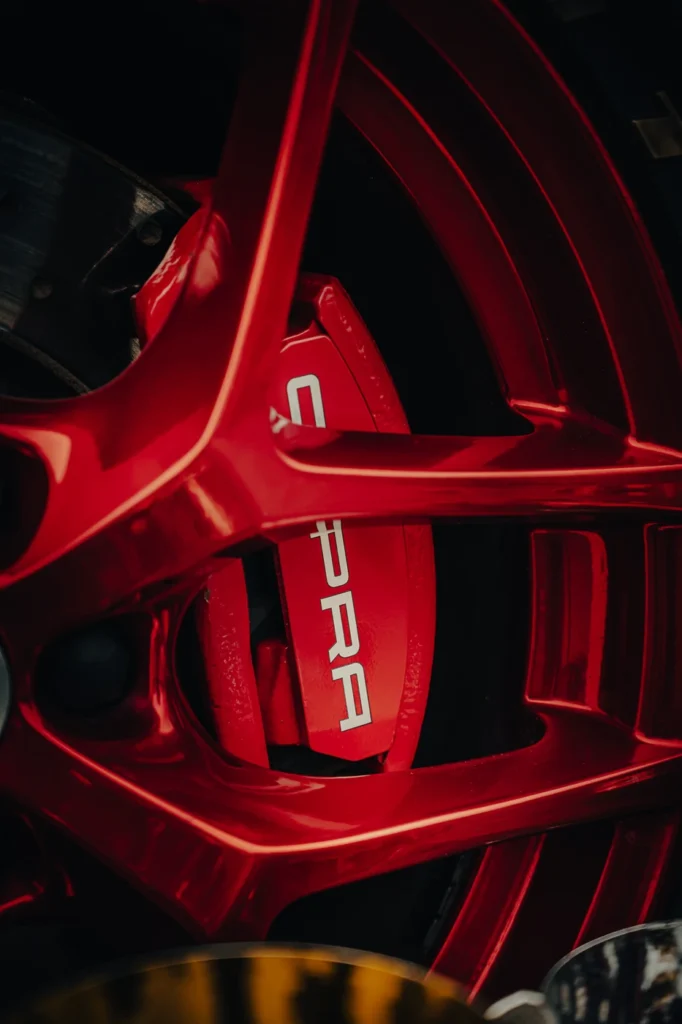 Red Cupra brake caliper visible between the spokes of a red wheel.