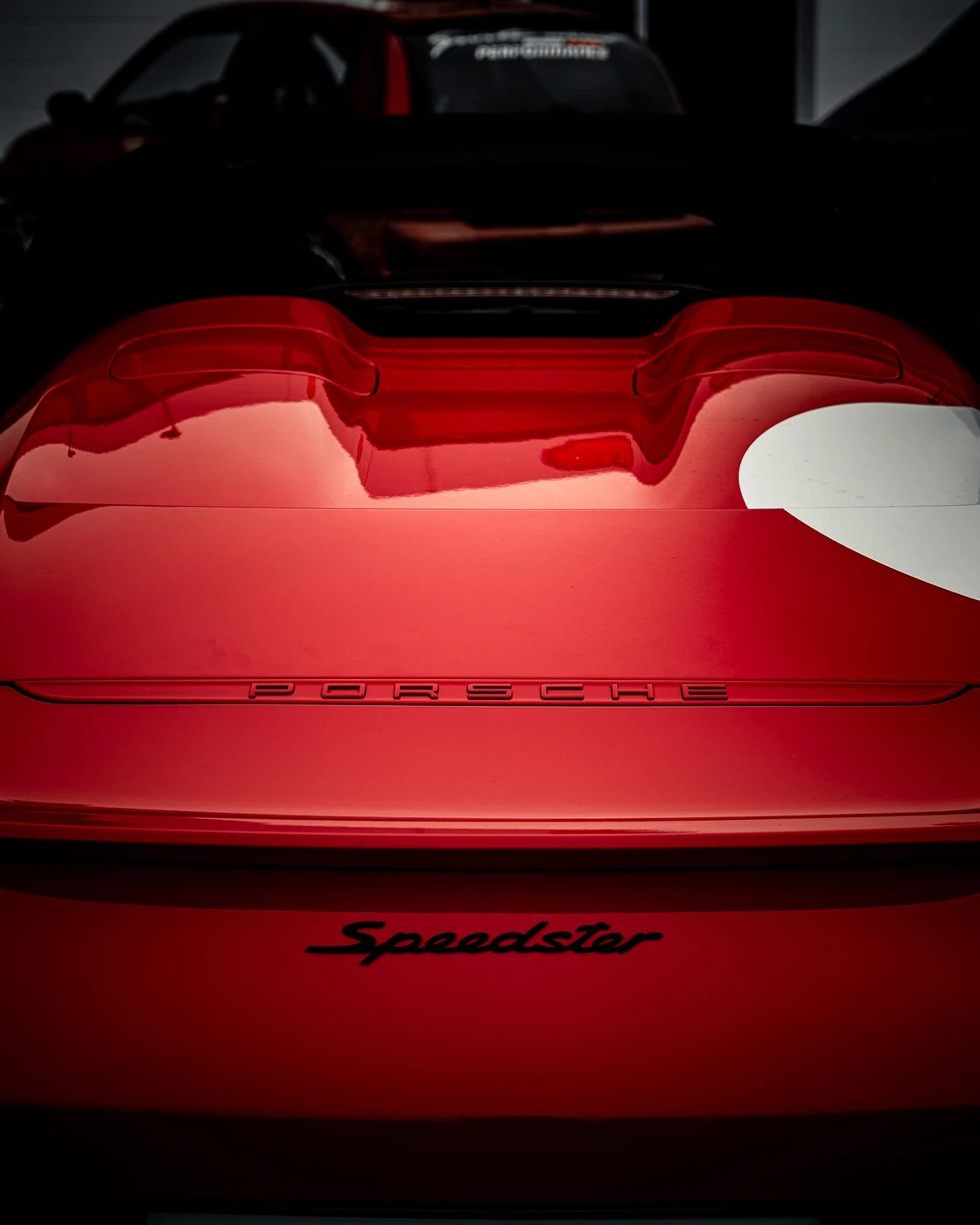 Glossy red Speedster rear detail with reflected light.