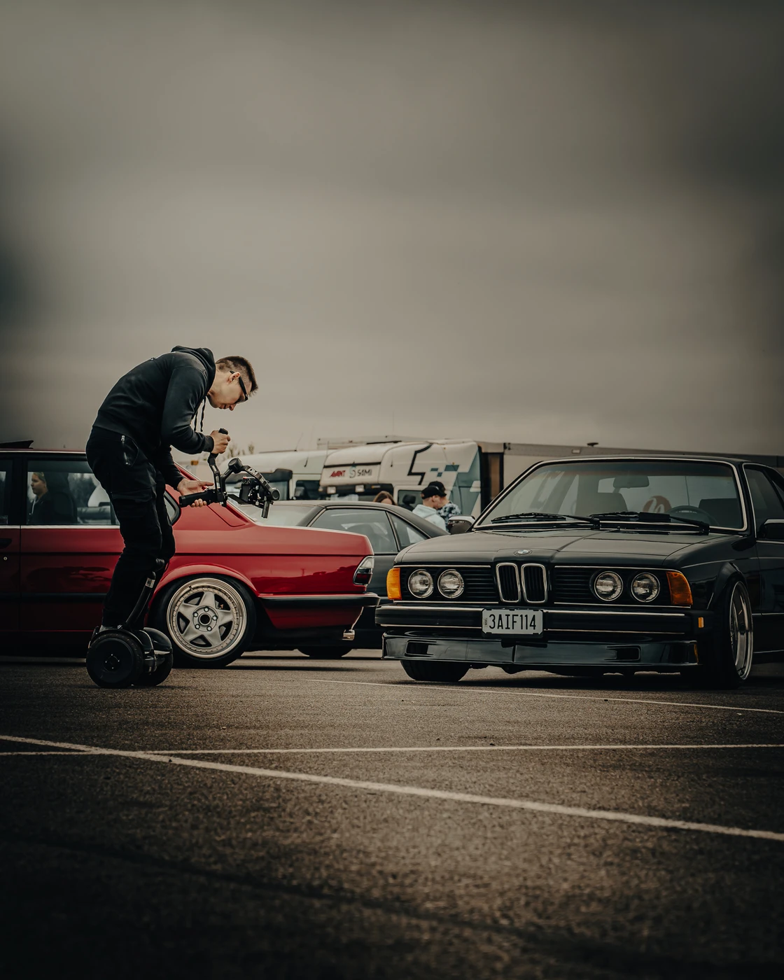 Person leaning over a classic BMW at Augustfest 2025.