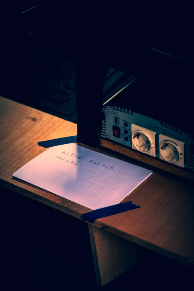 A handwritten note about the unfinished build lies on a wooden surface beside electrical sockets.