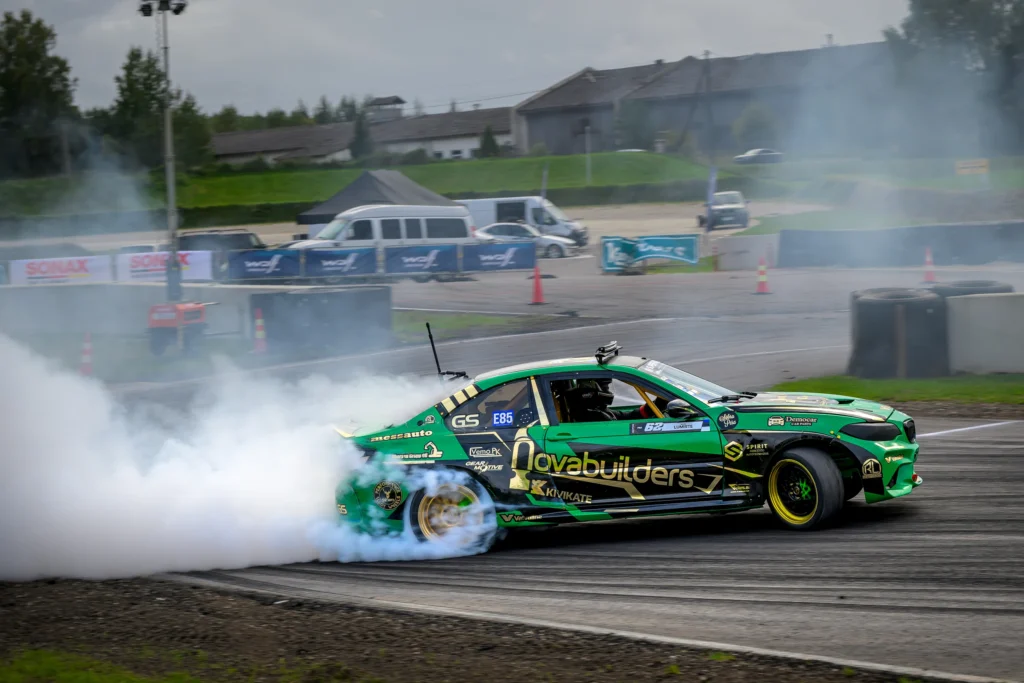 Roheline kollaste veljerantidega driftiauto külgvaates, taga tihe rehvisuits.