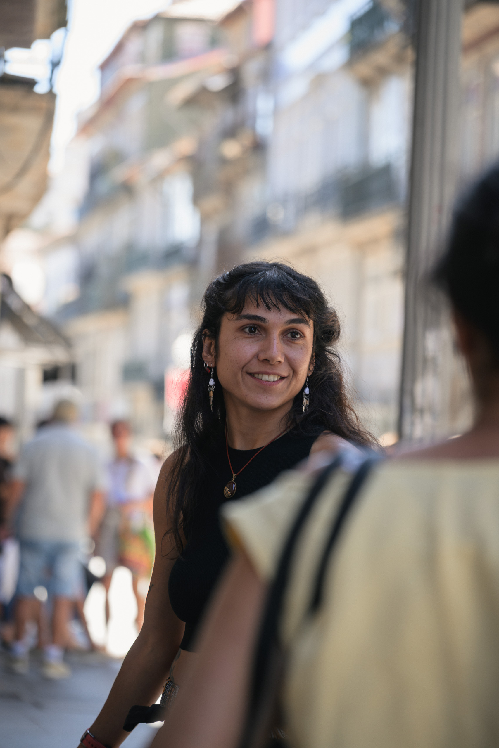 With preset. Street artist portrait in shade with a brighter city background — with the Cream Olive preset.