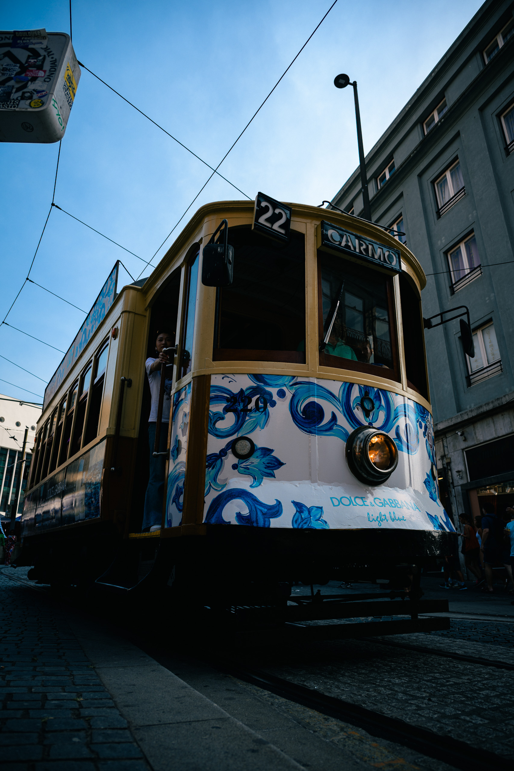 With preset. Porto tram in street shade below a bright sky — with the Urban Teal Amber preset.