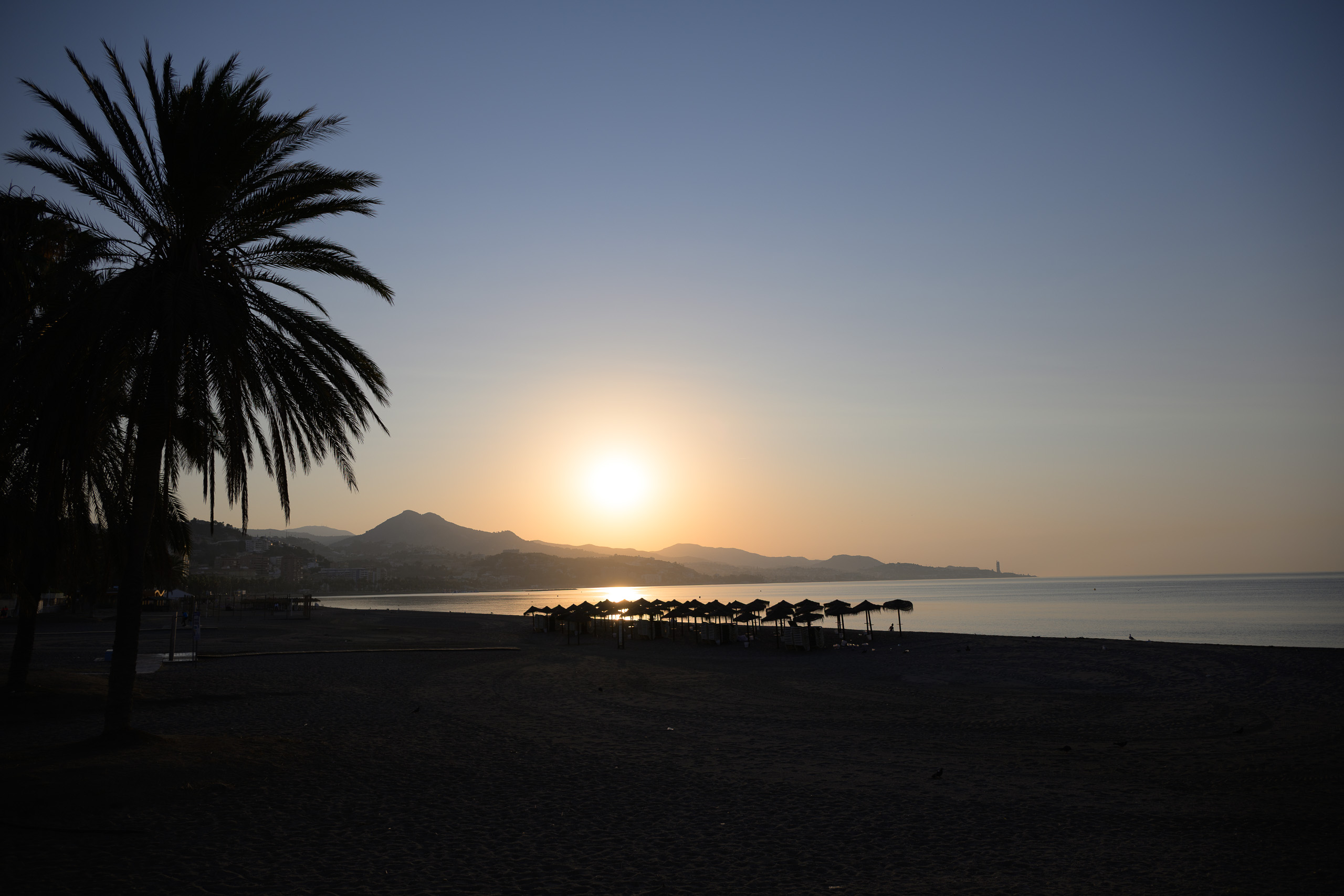 Before. Málaga coast in low golden morning light; this frame is sunrise — before applying the preset.