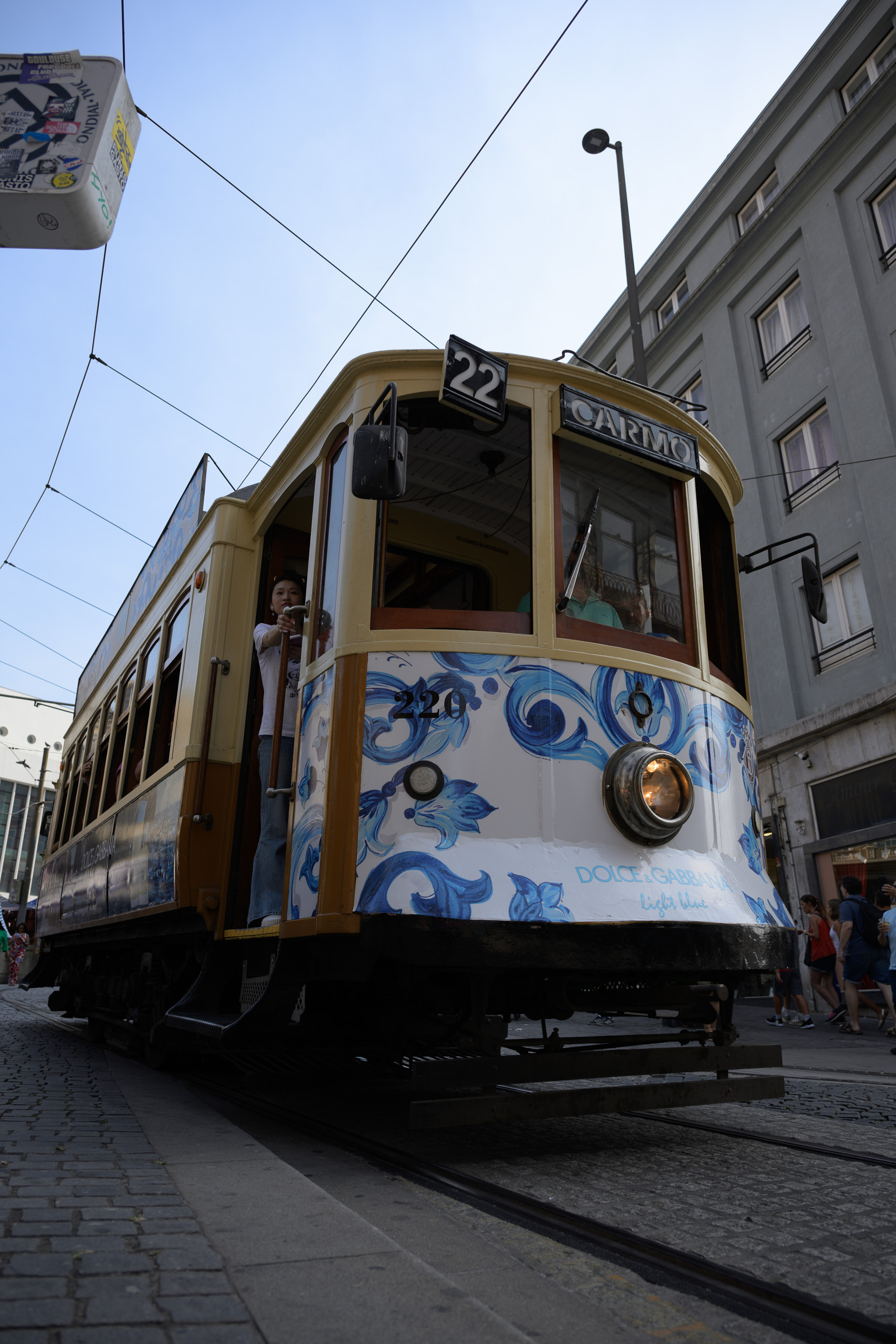 Before. Porto tram in street shade below a bright sky — before applying the preset.