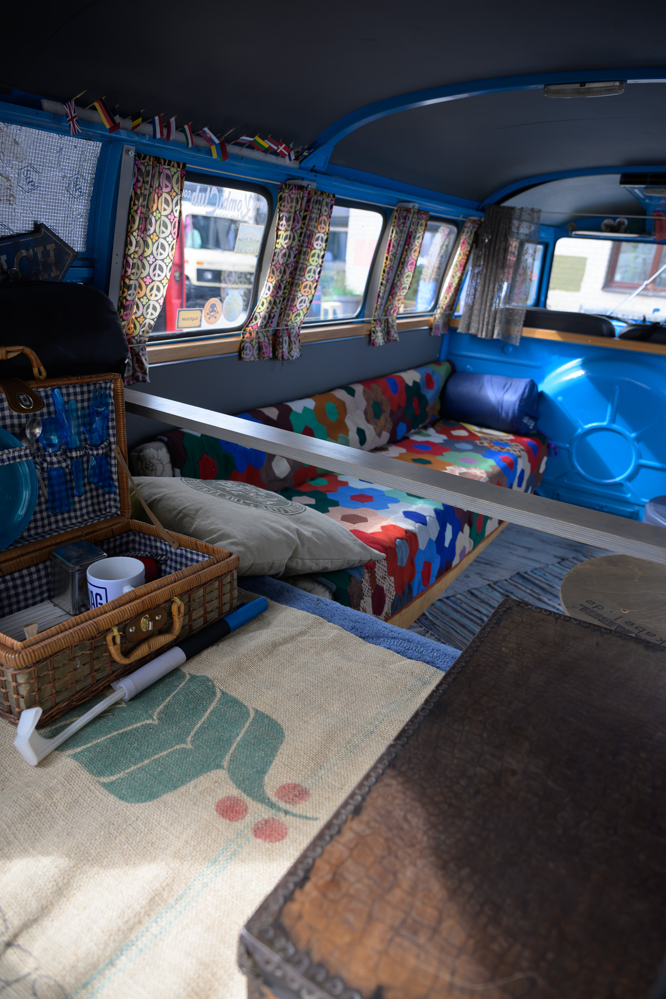 Before. A blue camper van interior in window light before applying the preset.