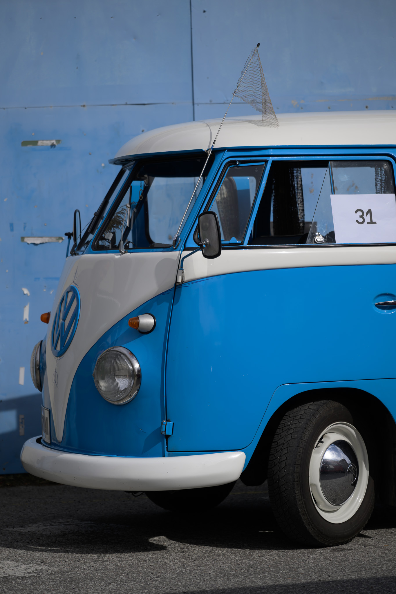 Before. A blue and white Volkswagen camper van in sunlight before applying the preset.